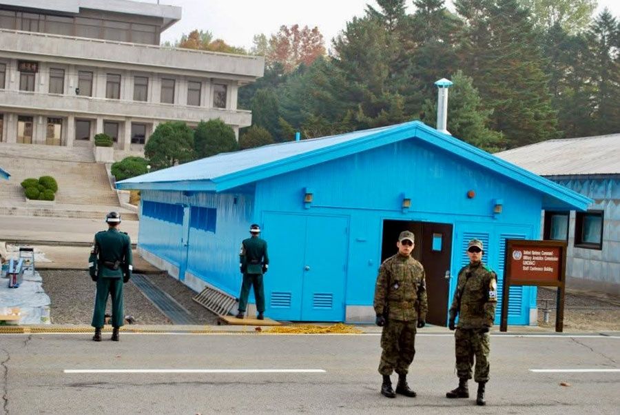 The line of division: In this 2012 snapshot, soldiers stand guard at the iconic blue United Nations Command conference buildings in the JSA. -- PHOTO: THE STAR / Asia News Network
