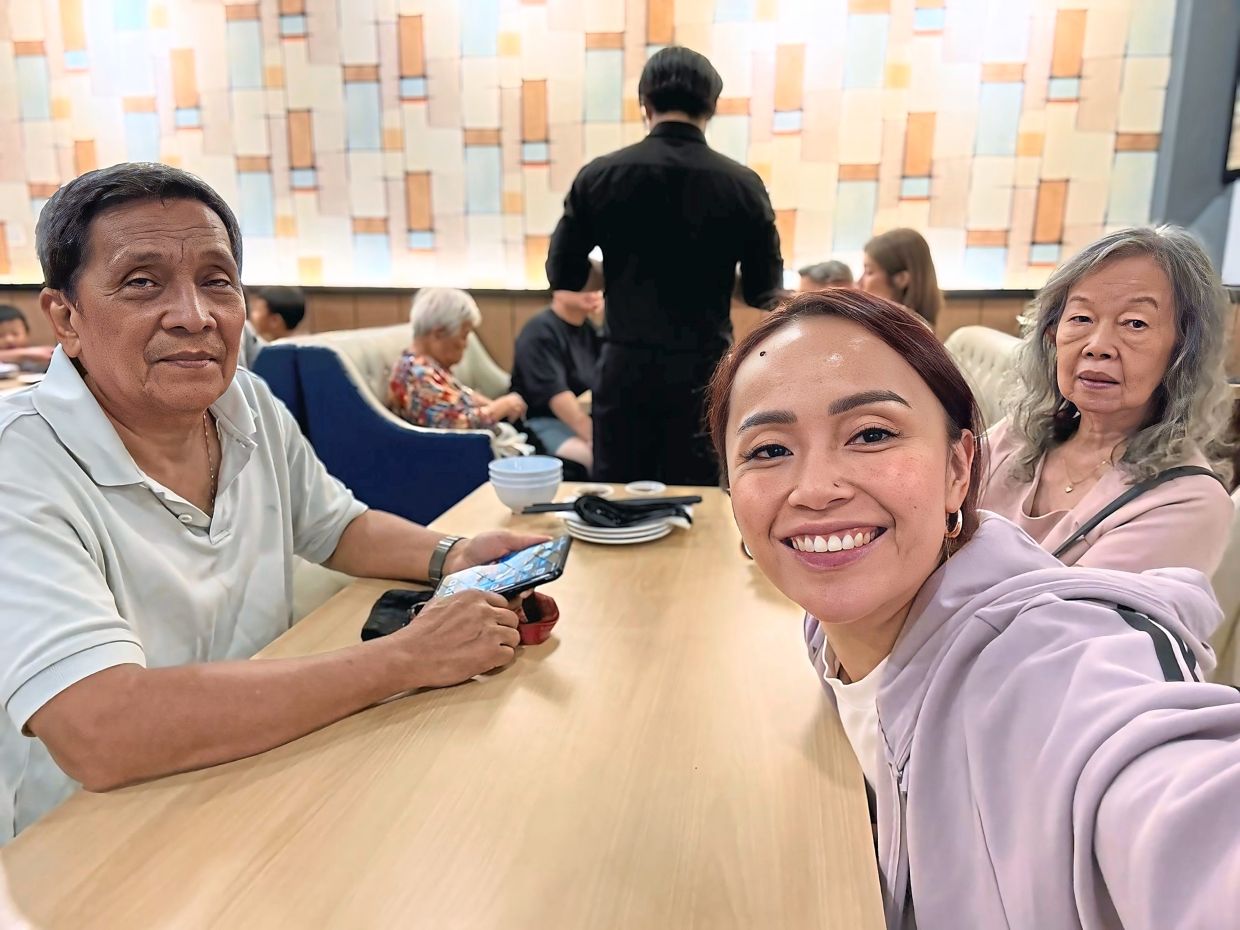 Adela (centre) with her parents, Jiram Sidu and Linda Jong. Photo: Adela Ida Jiram
