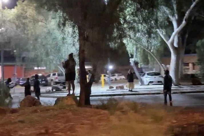 Her body was found on Thursday by one of hundreds of people searching harsh desert terrain around the town, a popular tourist destination in Australia's Northern Territory.