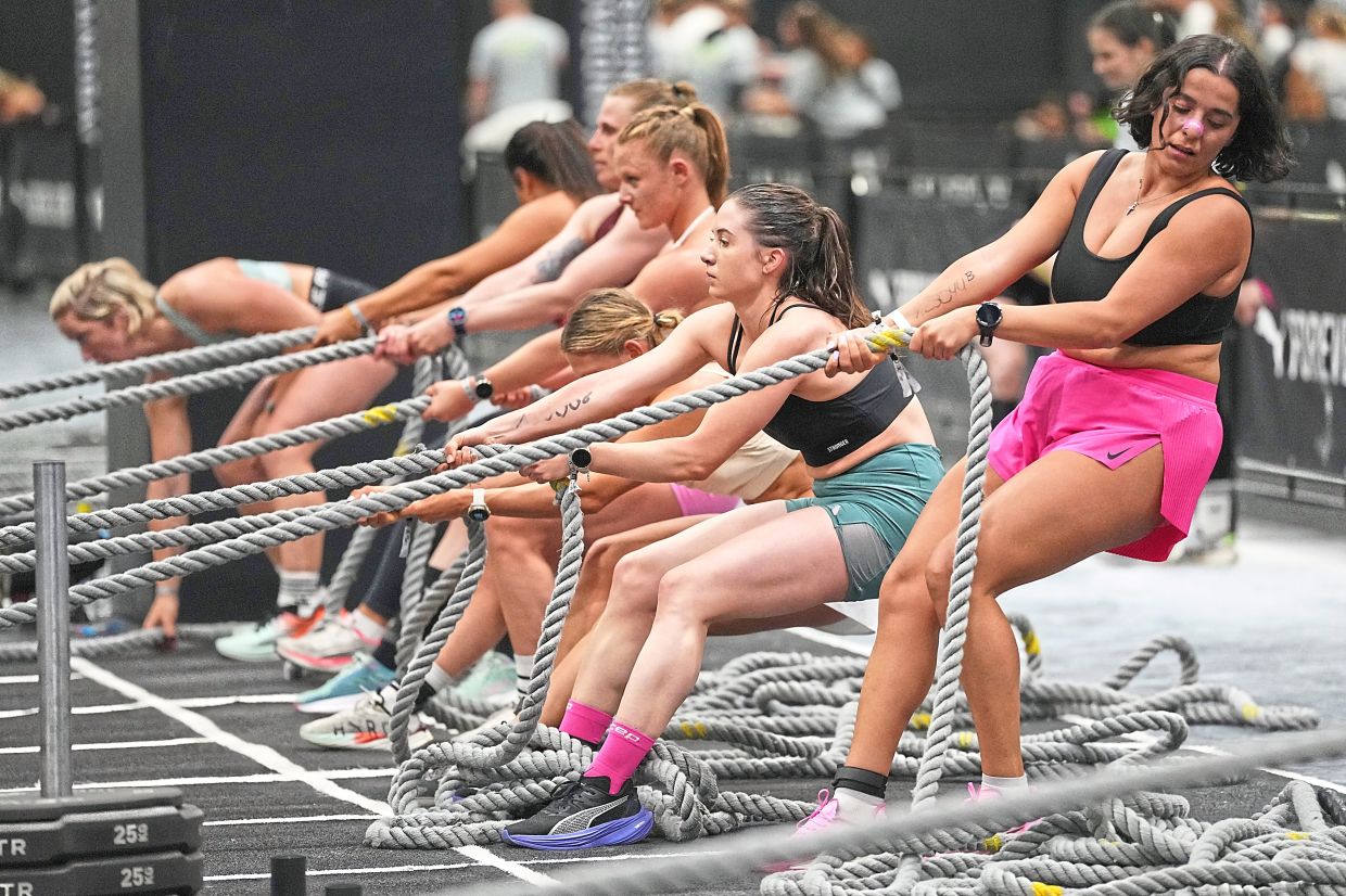 Women on the sled pull workout station, where they have to cover a 50m distance at their own pace.