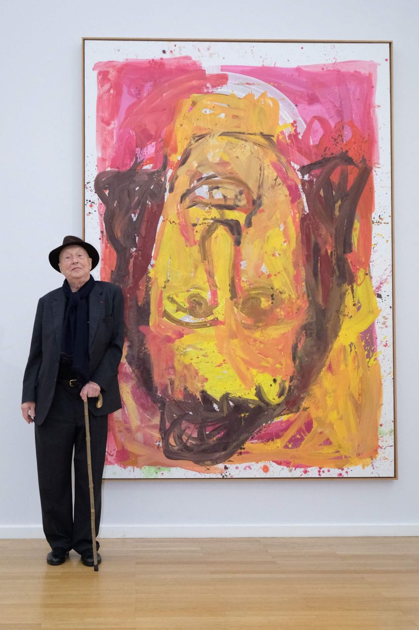 Baselitz poses next to his painting 'Schwester Rosi III from 1995 at his exhibition in Chemnitz, eastern Germany in April 2018. Photo: AFP 
