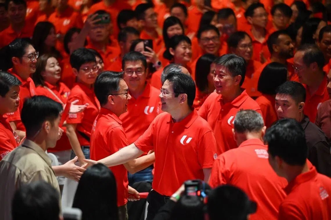 Prime Minister Lawrence Wong (centre) greeting some of the more than 1,600 union leaders and tripartite partners who attended the rally in Downtown East on May 1. - Photo: ST