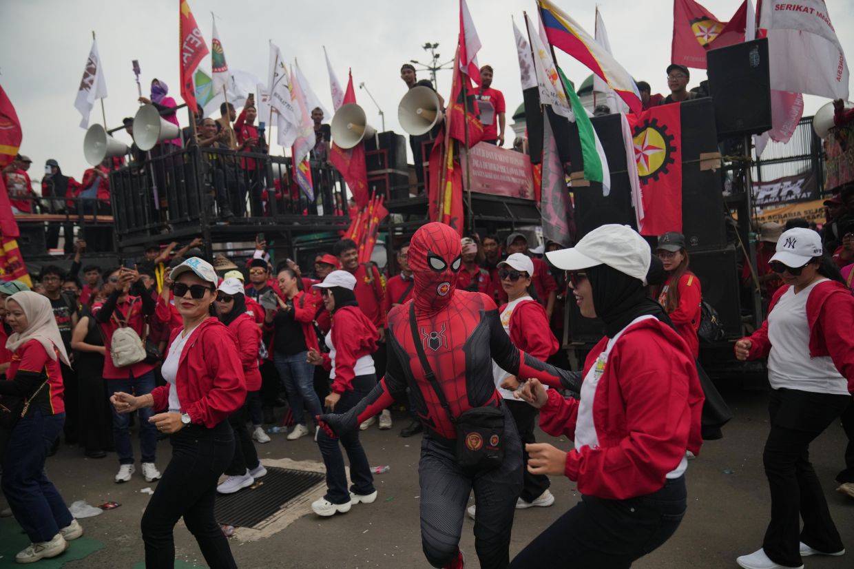 Labourers during a protest dance during a May Day rally in Jakarta, Indonesia, on Friday, May 1, 2026. -- AP Photo/Tatan Syuflana