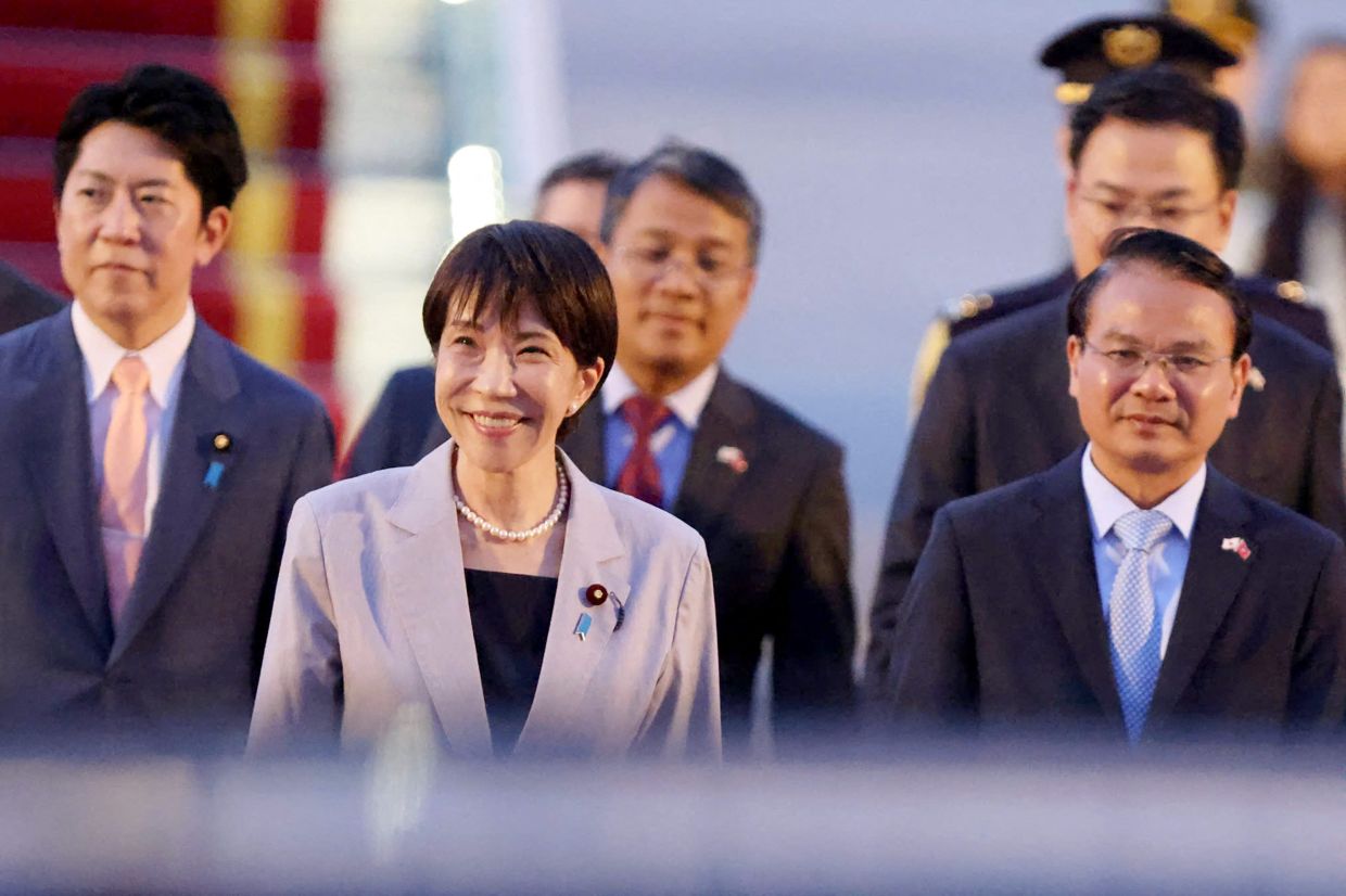 Japan's Prime Minister Sanae Takaichi (centre) is seen upon arrival at Noi Bai International Airport in Hanoi on Friday, May 1, 2026. -- Photo by Hoang Long / AFP