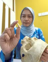 This dentist examines the dead