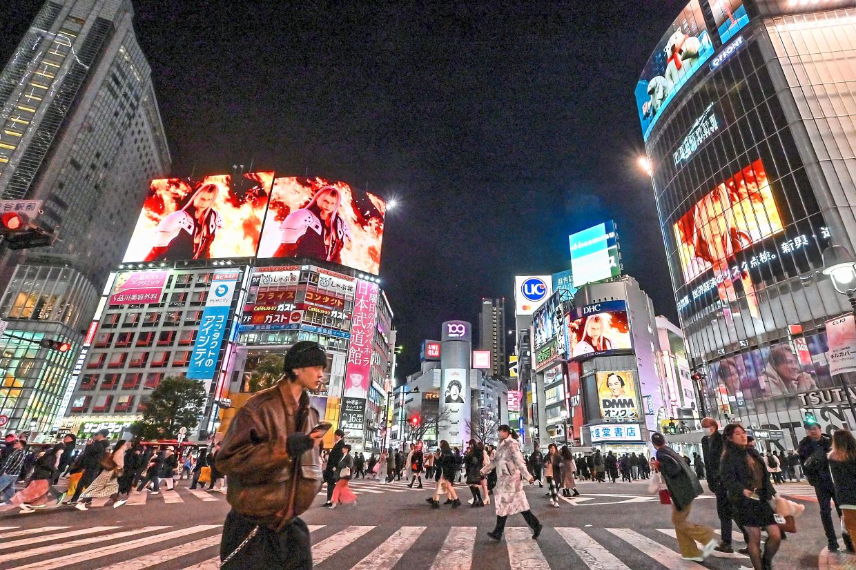 Pedestrians at Shibuya Crossing. Tokyo’s cleanliness reflects a profound sense of social responsibility. — Richard A. Brooks/AFP