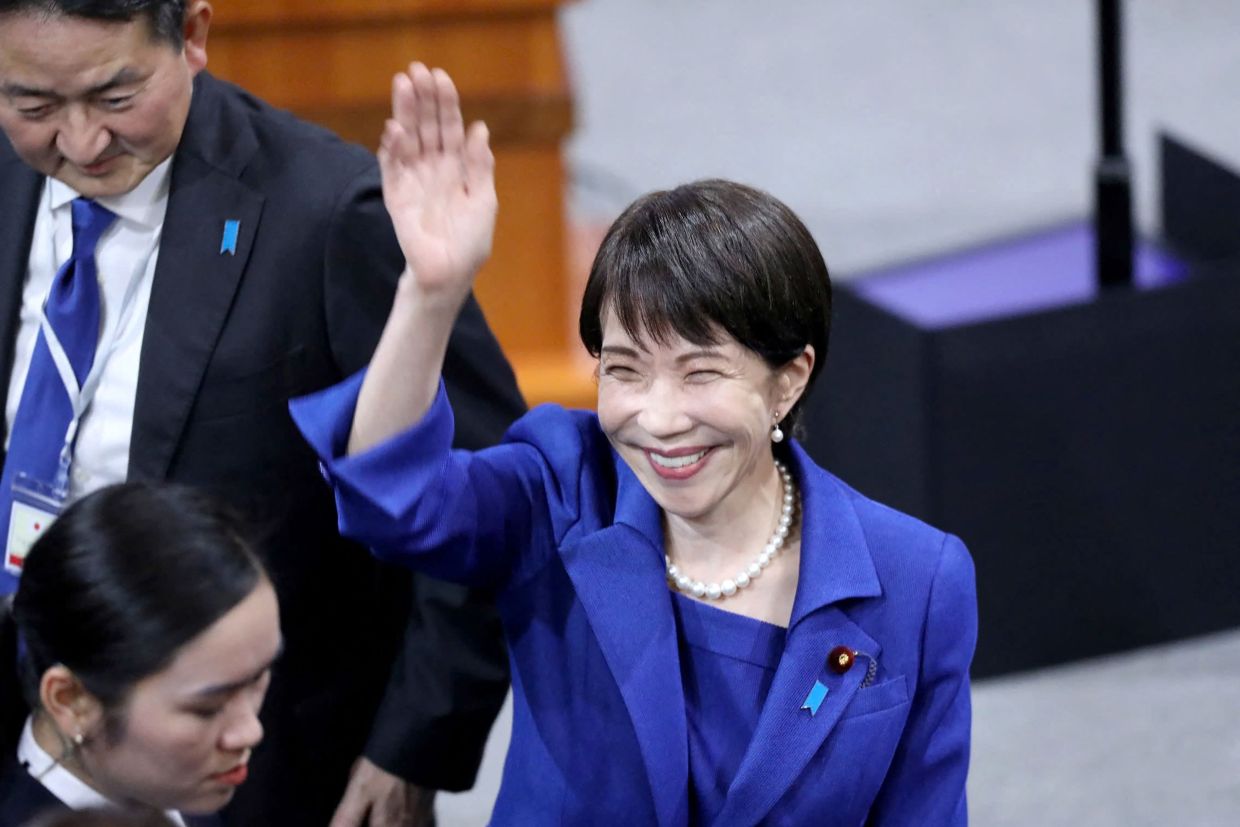 Japan's Prime Minister Sanae Takaichi greets attendees at the auditorium of Hanoi National University in Hanoi on Saturday, May 2, 2026. -- Photo by Hoang Long / AFP