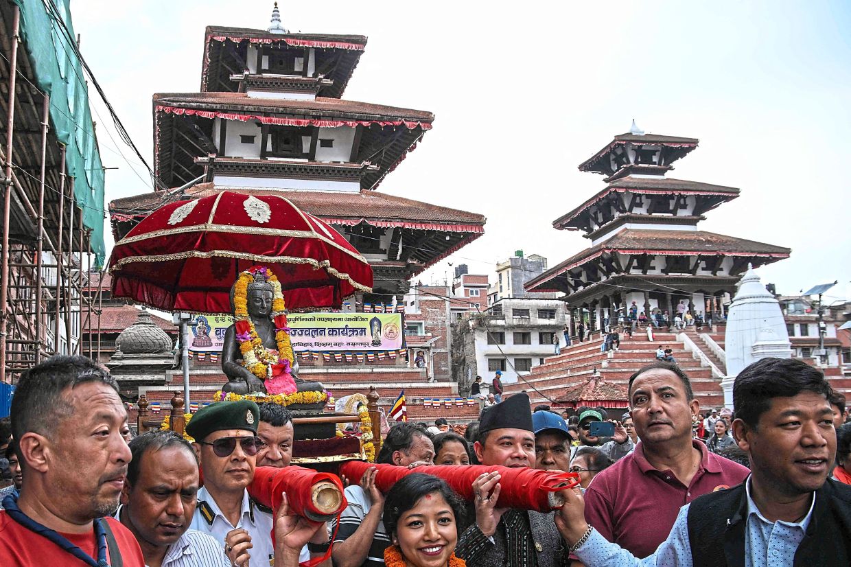 The statue, dating back to the 13th century, was carried in a palanquin back to its pagoda-style temple in the capital Kathmandu to the sound of traditional music on Friday.