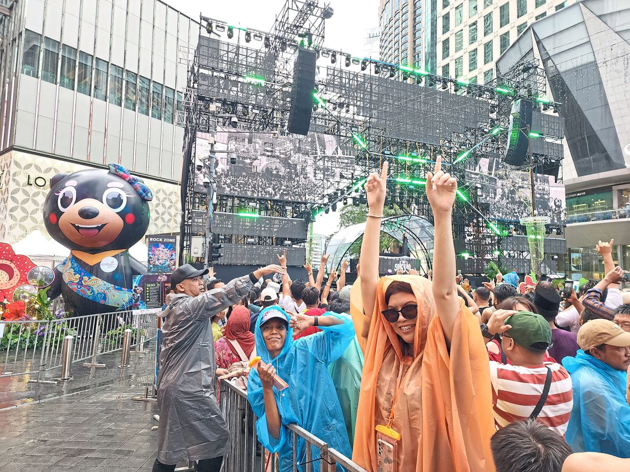 Feena (in orange raincoat) wants to have fun dancing in the rain.