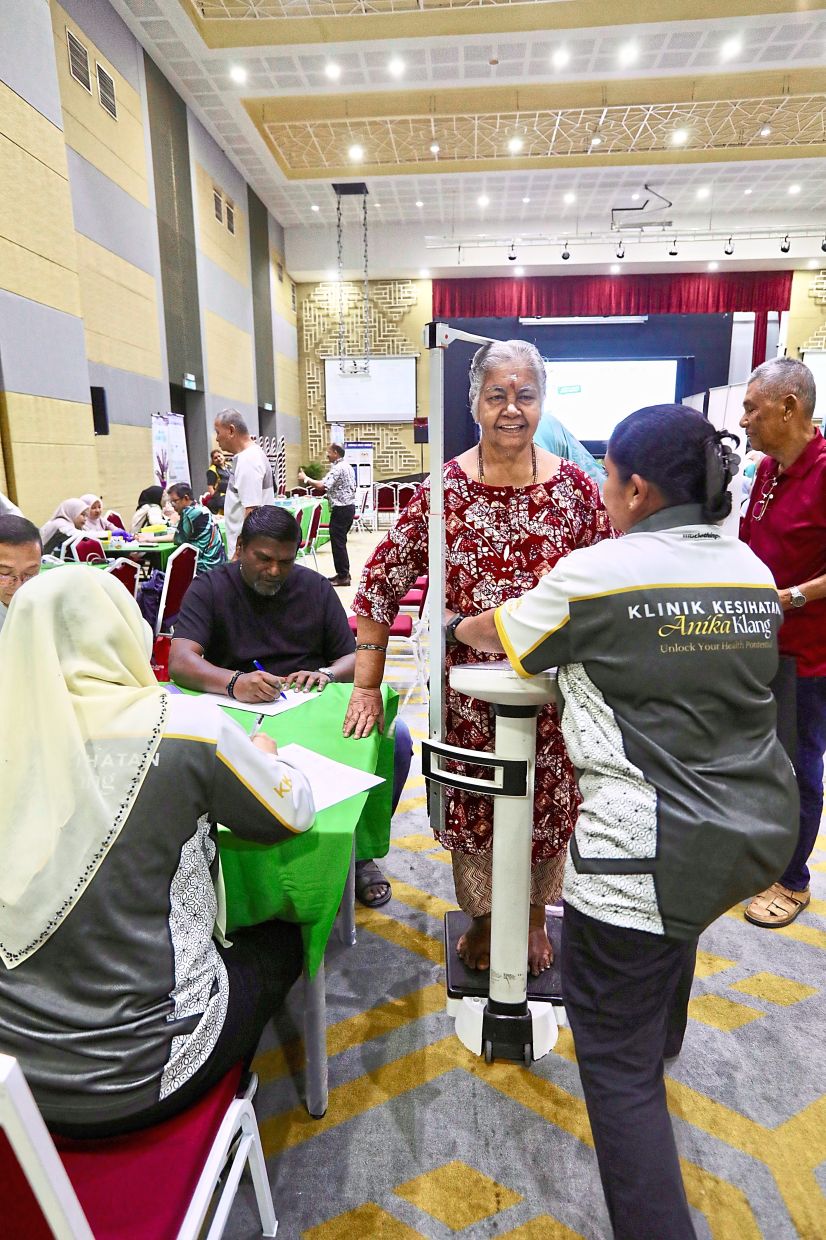 A visitor having her BMI checked before getting the eye test.