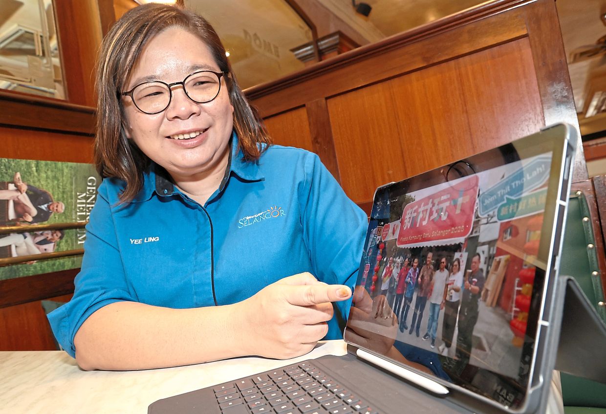 Chua showing a photo of the inaugural Selangor New Village Fiesta in Pandamaran in Klang district. — ART CHEN/The Star