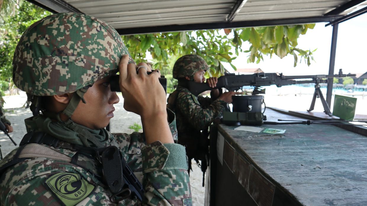  Security personnel maintain vigilance at a control post in Pulau Langkayan.