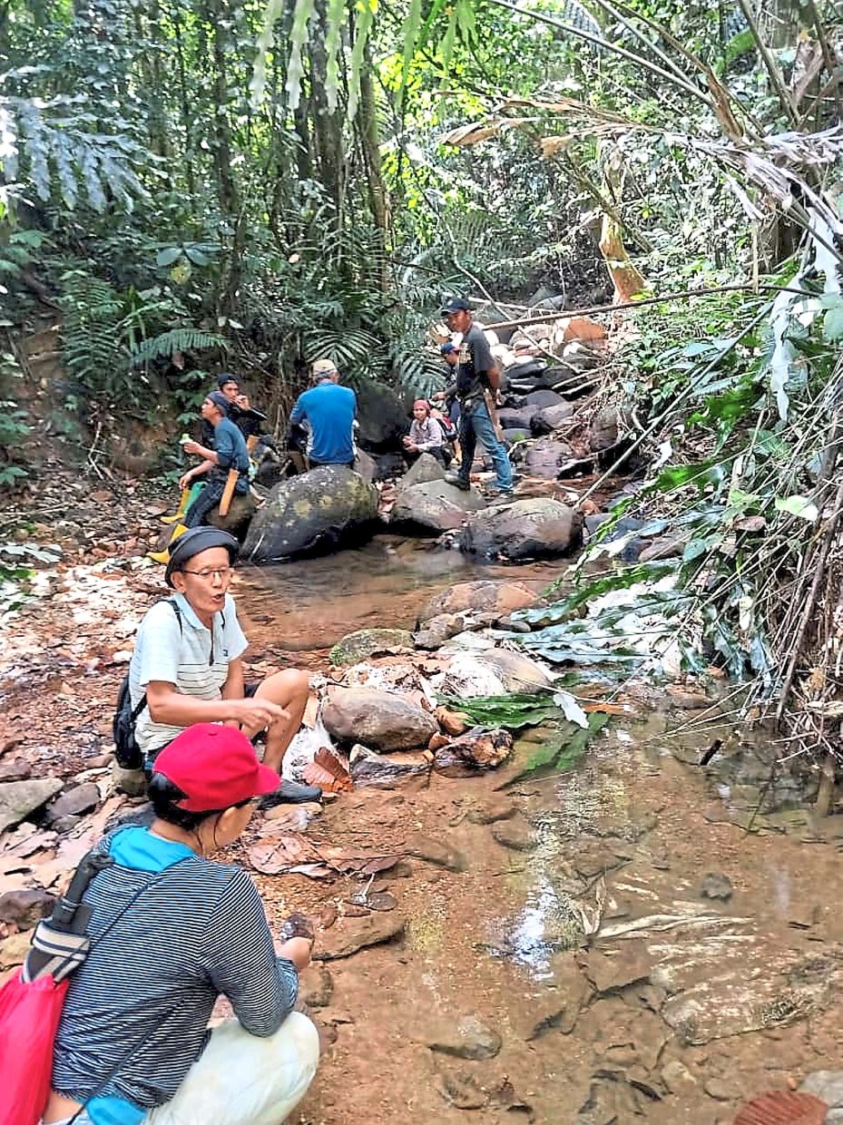 Looking for water: Villagers taking a break from their search for a water source at a stream.