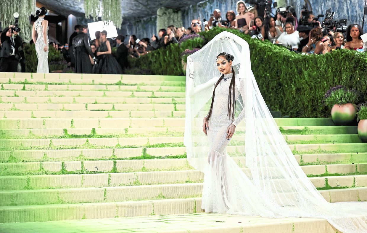 Lisa poses in an outfit featuring an extra set of arms. Photo: Reuters