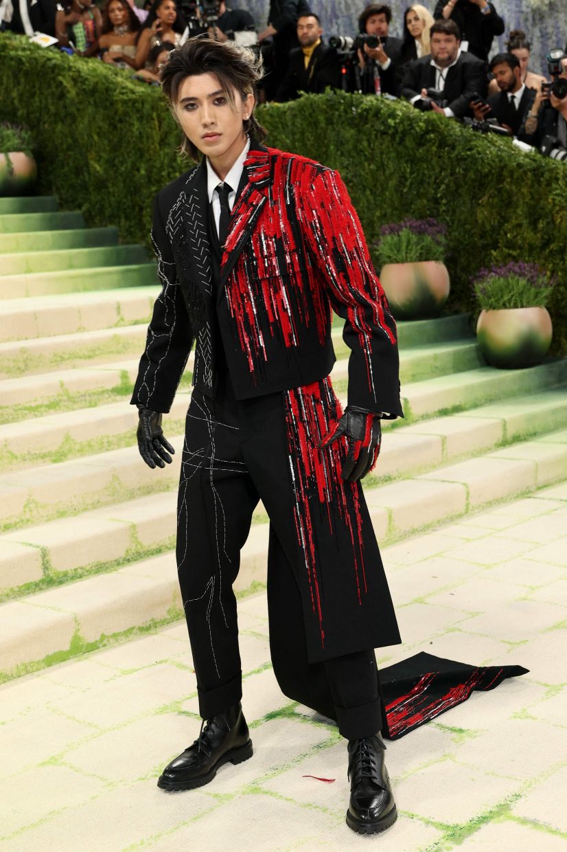Cai Xukun looks fierce in a jacket that looks like it is dripping with red paint. Photo: AFP