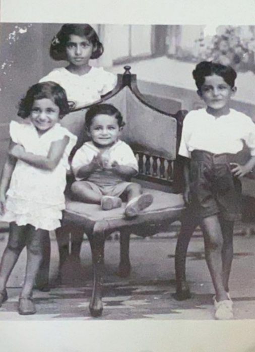 A childhood photo of Annie (back row) with her siblings, Easau (right), George (seated), and Susie.