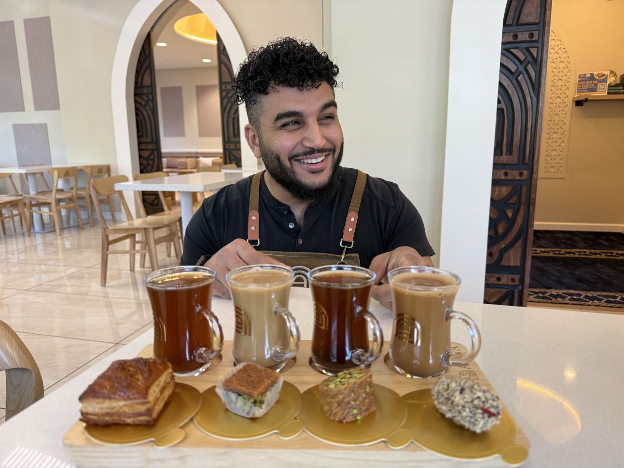 Franchisee Ahmad Badr serves a drink and treat sampler at Arwa Yemeni Coffee on April 6, 2026, in Sunnyvale, Calif. (AP Photo/Haven Daley) 