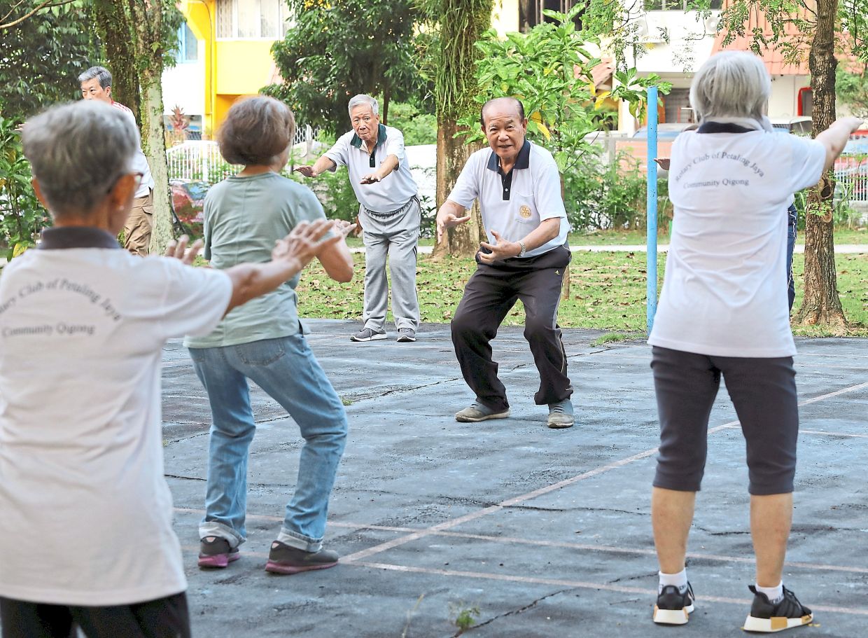 Chin running a qigong session for seniors in Taman Megah, Petaling Jaya. The programme held at a small neighbourhood garden is supported by MBPJ to promote an active lifestyle, social connection, overall well-being and a healthy community.