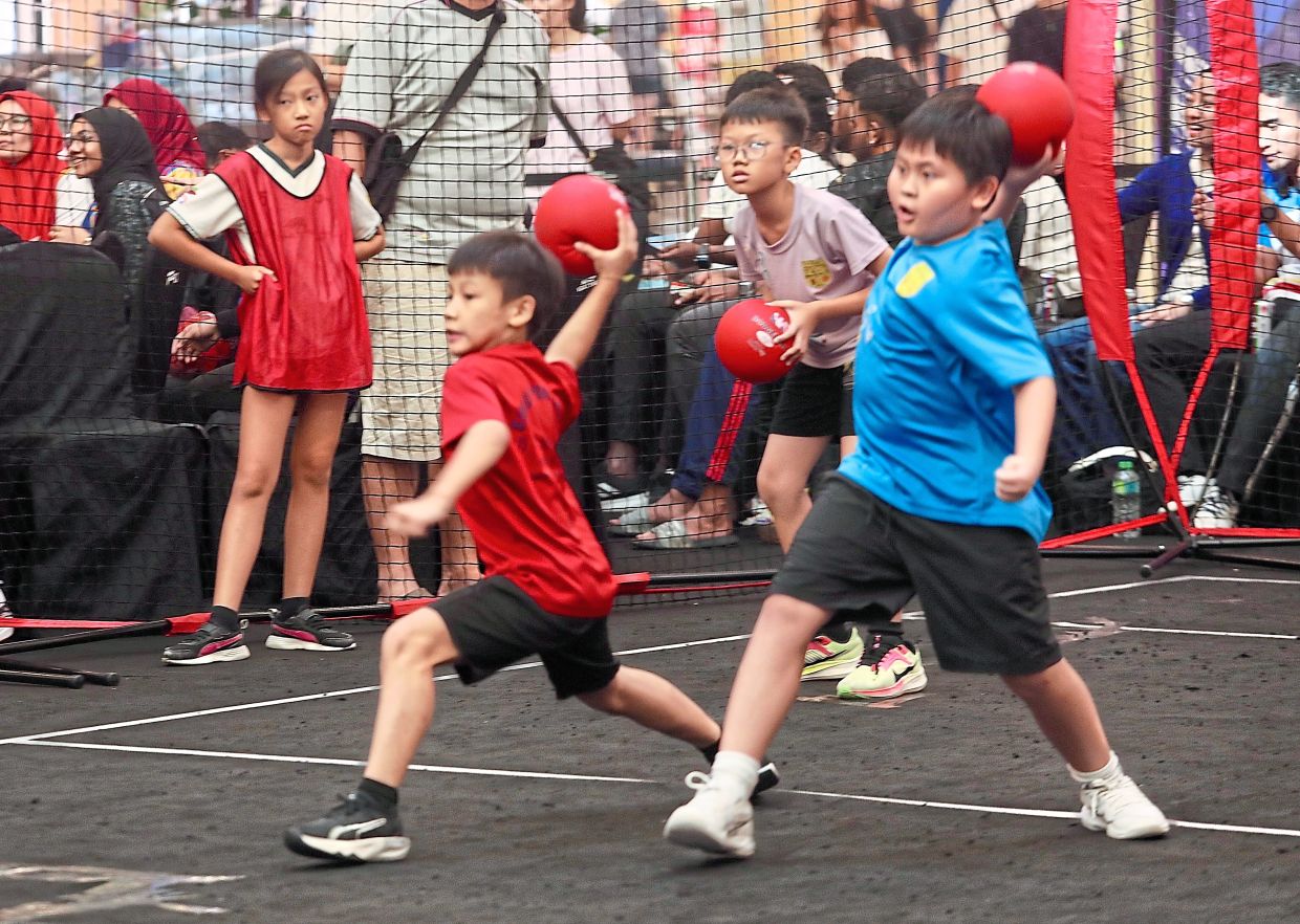 Children participating in the Under-12 competition playing with foam dodgeballs.