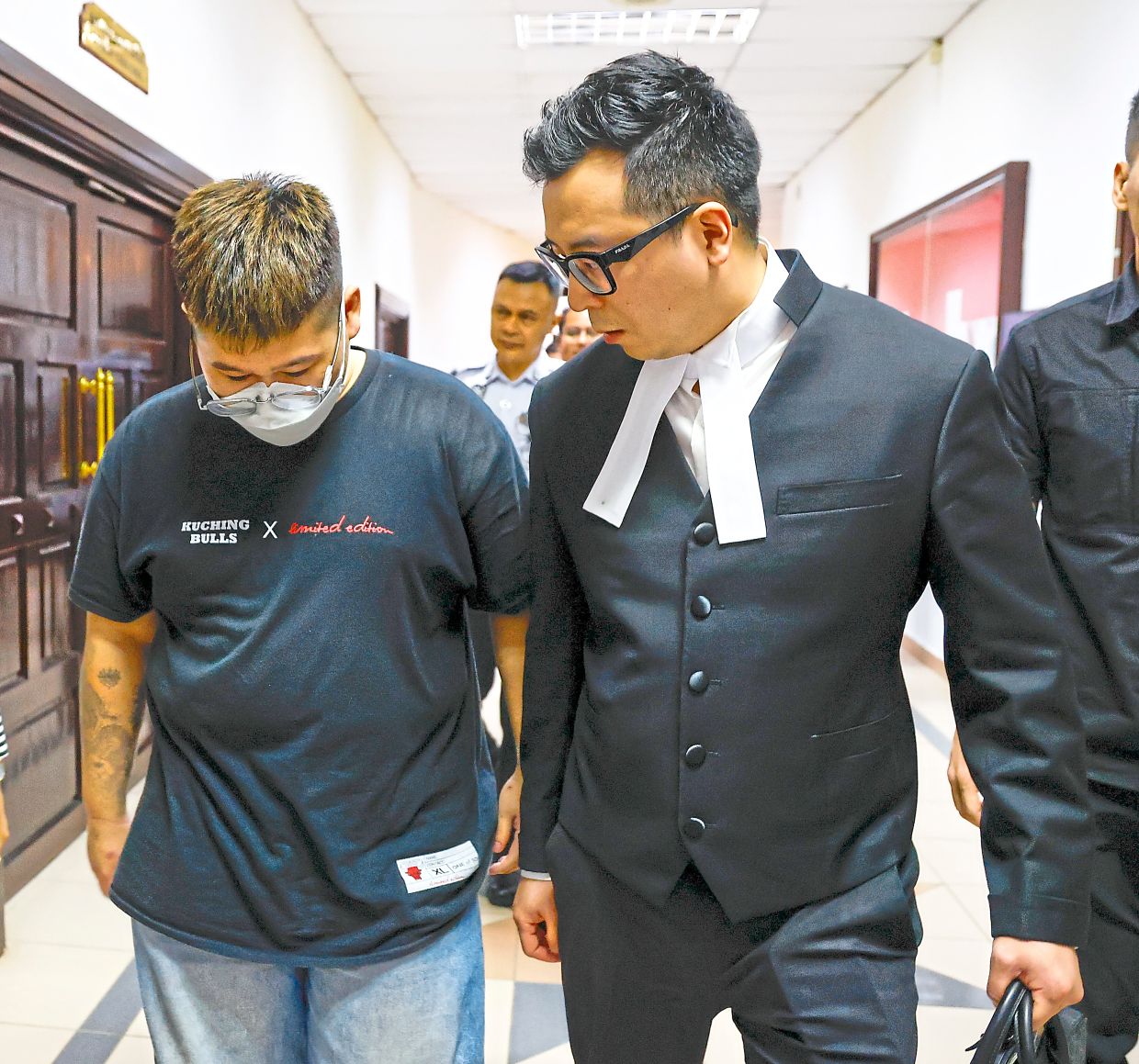 The accused: Yeo (left) leaving the courtroom with his lawyer after pleading not guilty to a charge of reckless driving. — ZULAZHAR SHEBLEE/The Star