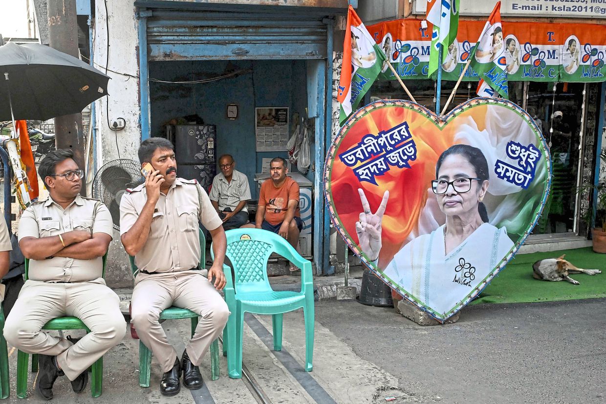 On alert: Police personnel guarding the road leading towards Banerjee’s residence in Kolkata, after her party lost the recently concluded state legislative assembly elections. — AFP