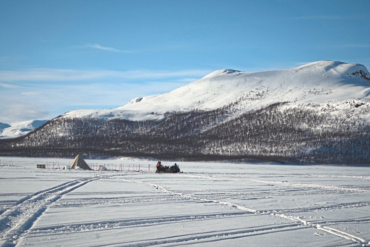 A snowmobile parked at Lake Kilpisjarvi.