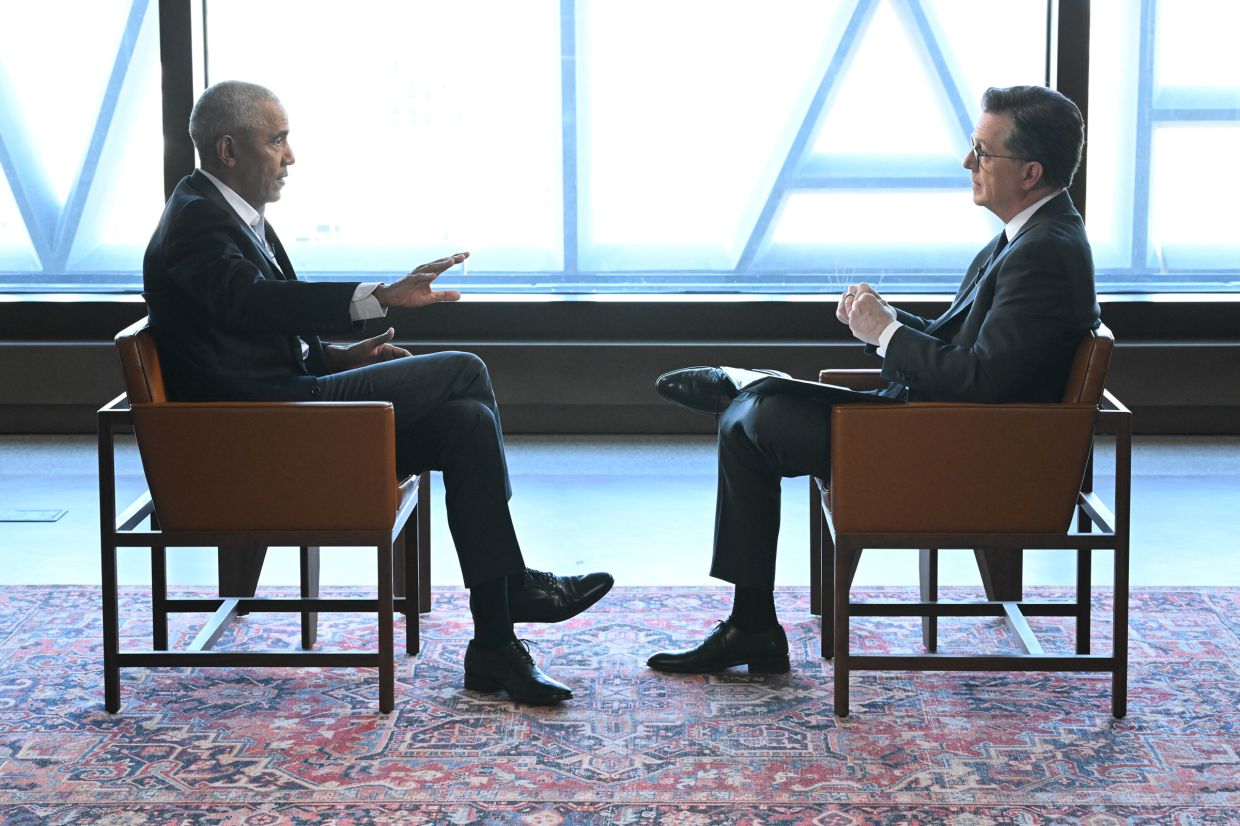 Former President Barack Obama (left) speaks with Stephen Colbert in an interview taped inside the Obama Presidential Center in Chicago. Photo: Handout