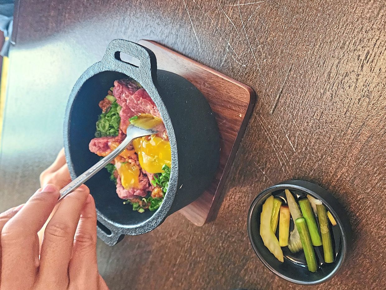 The wagyu beef kimchi hot pot rice highlights flavourful rice and tender beef cooked in a hot stone pot. — ABIRAMI DURAI/The Star