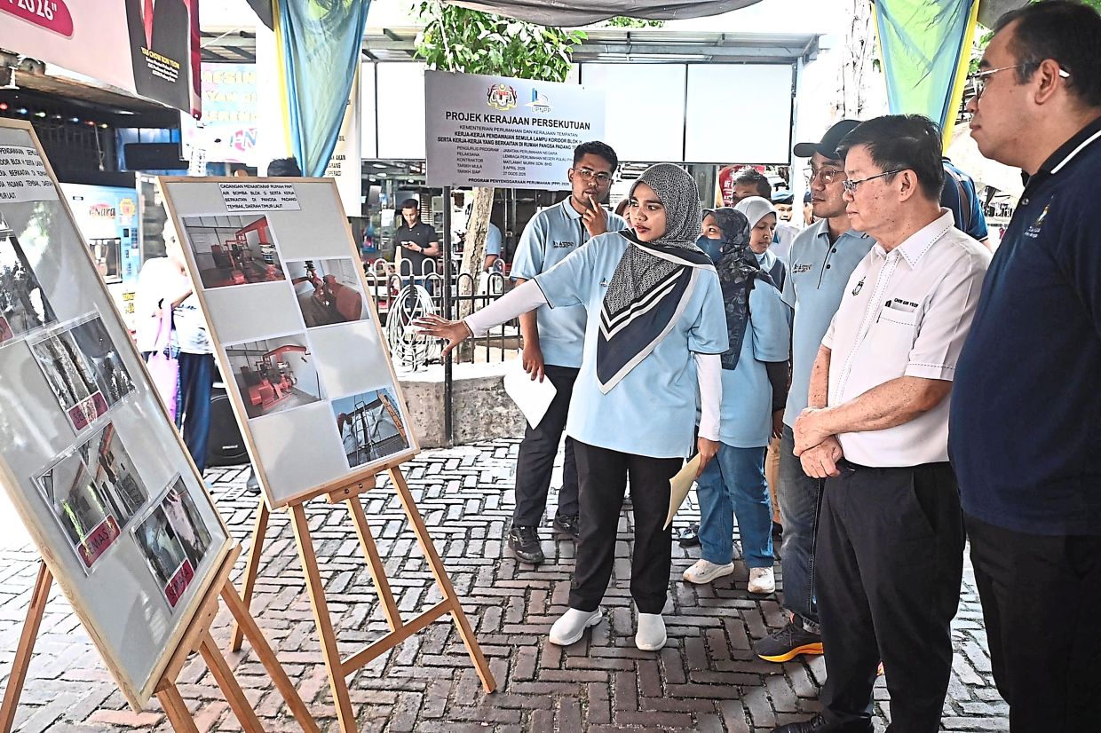 An LPNPP officer briefing Chow on plans to repair the fire pump house system at Block G. 