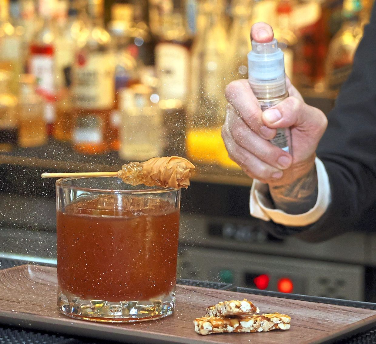 A spray of edible glitter to elevate the Nuts About Earl cocktail.
