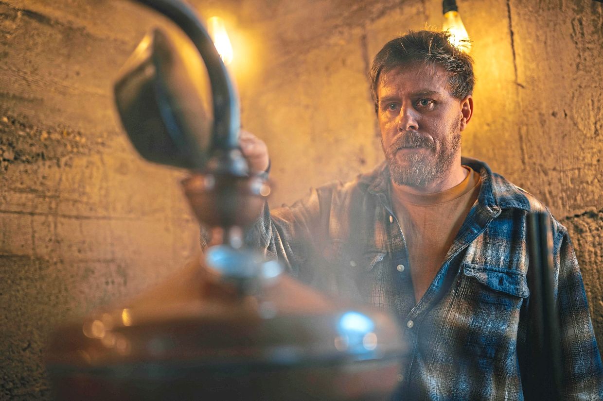 Lakatos working on the distillation process in his gin distillery in Belegis.