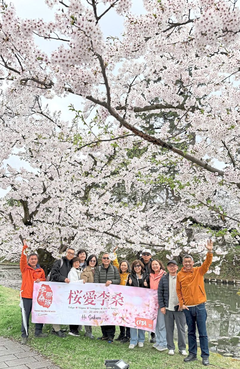 The writer (far right) with his travel buddies at a park where the Somei Yoshino, Japan’s most common cherry blossom, is blooming.