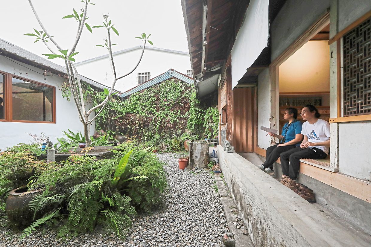 Tourists sitting in an old house-turned-dessert-shop in Fenglin.