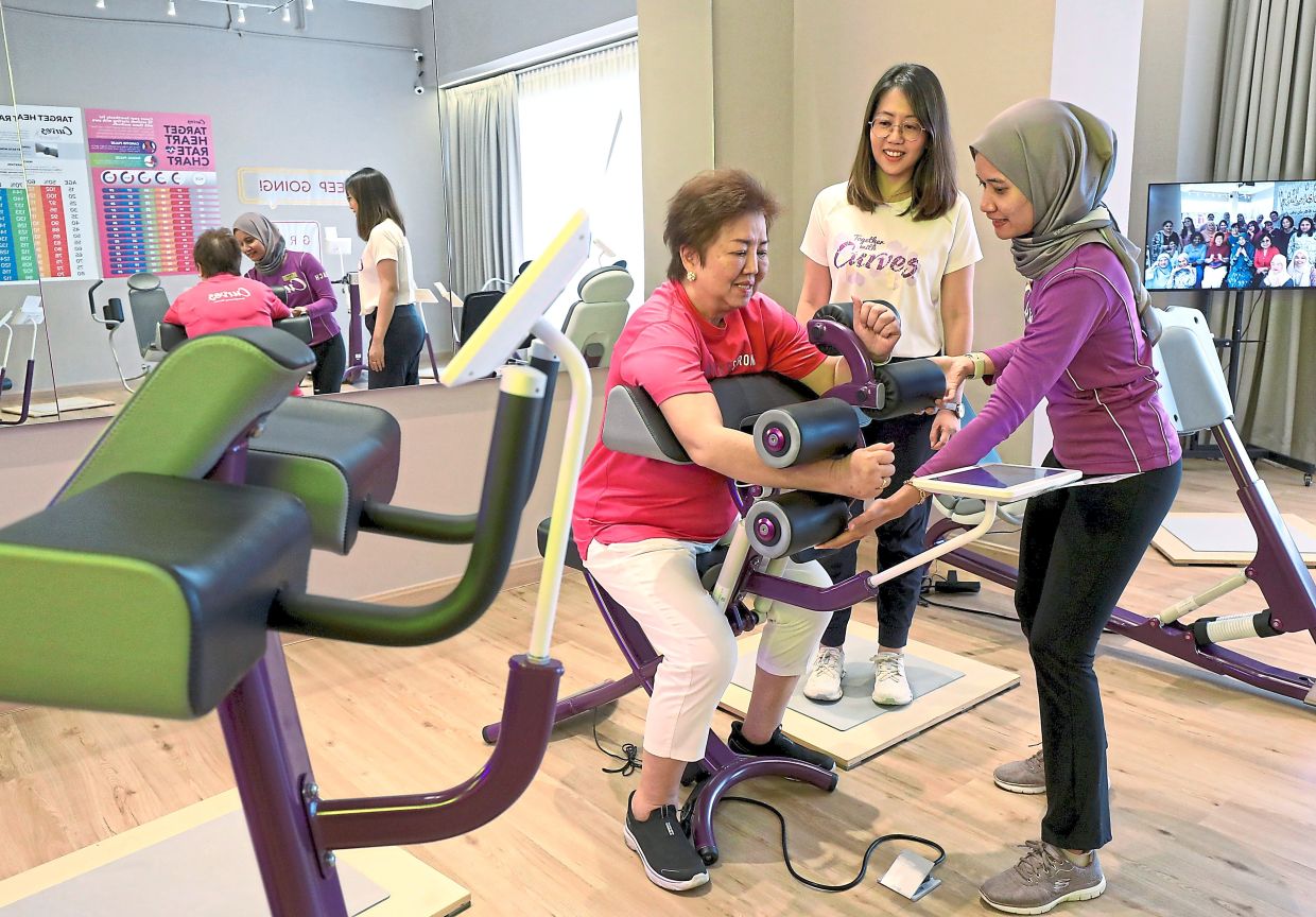 Margaret (left) with Allison (centre) during a gym workout.