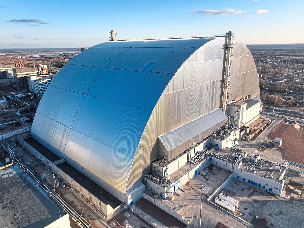 A drone view of the roof of New Safe Confinement, a structure that covers the old sarcophagus which confines the remains of the damaged fourth reactor, which was damaged by a drone strike on Feb 14 amid ongoing Russia’s attack on Ukraine, at the Chernobyl Nuclear Power Plant, in the Kyiv region in Ukraine on Nov 19 last year. — Reuters