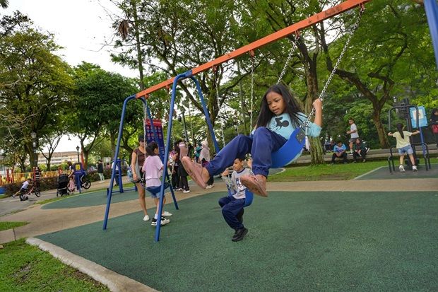 Kids playing on a swing at Taman Metropolitan Kepong.