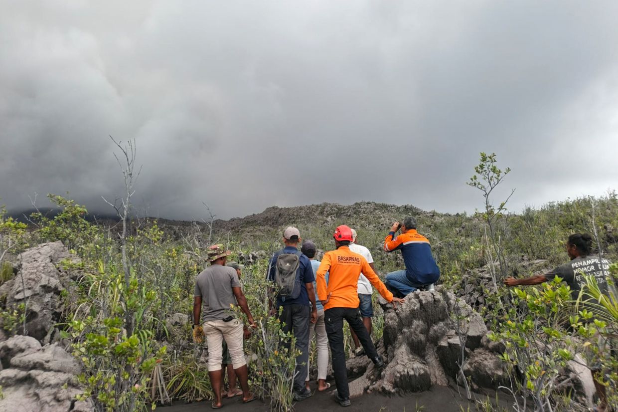 The woman, identified by authorities only as Enjel and known as a local hiker, was located Saturday afternoon, about 50 meters (165 feet) from the rim of the main crater.