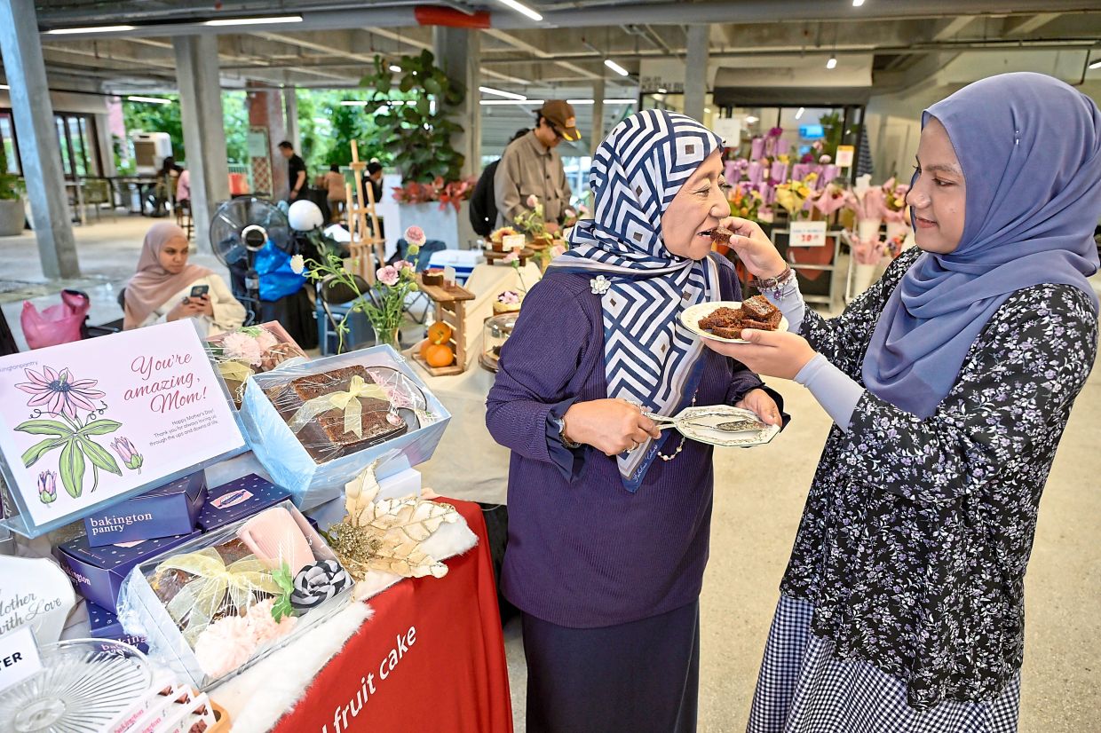 Zaiton (left) and Alysha doing a final check of the cakes on sale at the Mother’s Market.