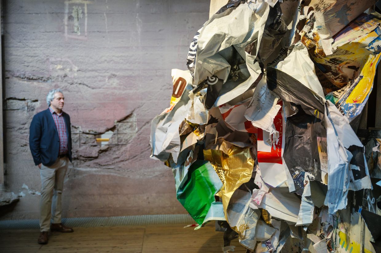 Frank Kraemer, exhibition director, stands next to the installation 'Affichage Libre' by artist Joachim Romain at the Urban Art Biennale 2026. Photo: AP