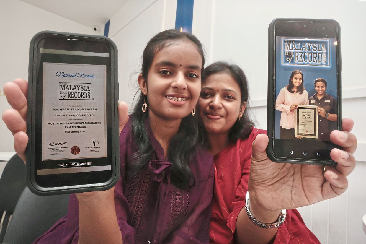 Hidden talent: Poonyamitra and mum Thilagam displaying pictures of the Malaysia Book of Records’ certificate. — ZHAFARAN NASIB/The Star