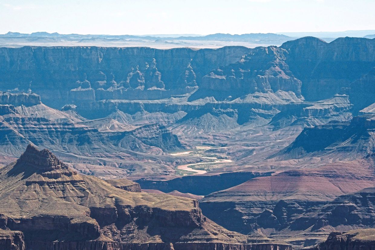 The Colorado River snakes through the canyon as seen from the south rim of Grand Canyon National Park.