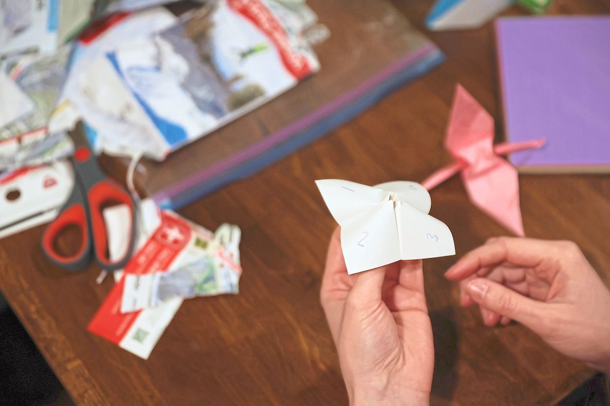 (pls use) An origami game from the 90s is part of the activities at the phone-free gathering.