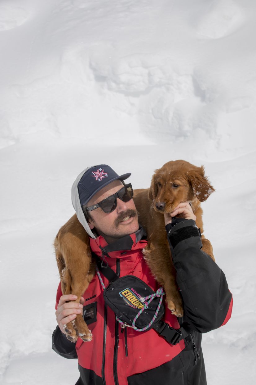 Baggs, a young golden retriever training to be an avalanche rescue dog, with her owner, Rob Brennan, a Jackson Hole ski patroller.