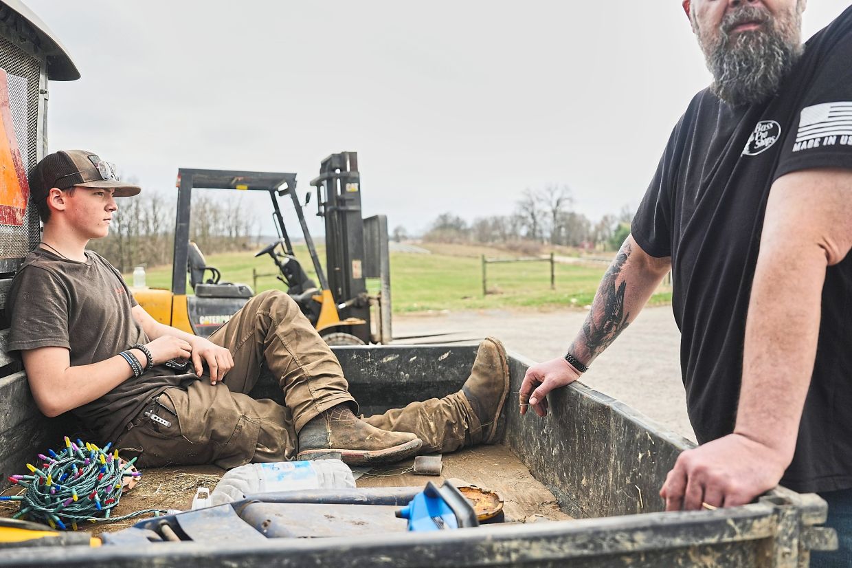 Blake (left) relaxes in the back of a farm vehicle in Canfield, Ohio.