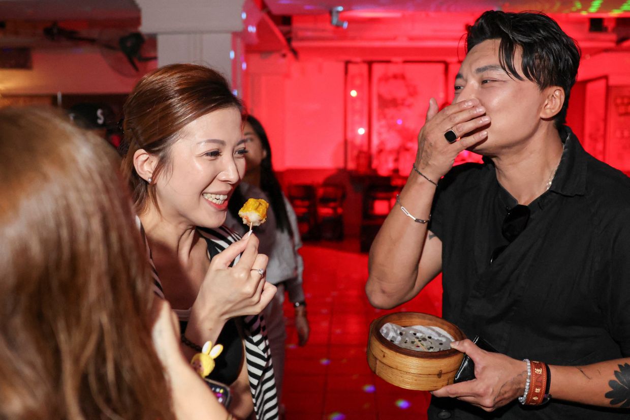 Customers enjoy siu mai at Lin Heung Lau teahouse during its farewell dim sum rave party.