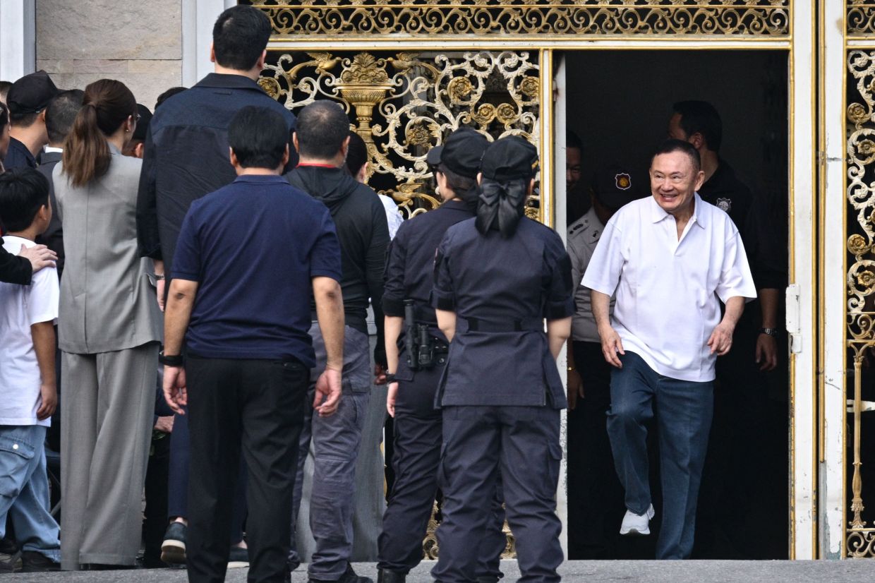 Thailand's former prime minister Thaksin Shinawatra (right) is greeted by his family members and relatives upon his release at Klong Prem Central Prison in Bangkok on May 11, 2026. Thailand's former prime minister, Thaksin Shinawatra, was released early from prison on Monday, May 11, raising the prospect of a return to the spotlight for the political heavyweight. -- Photo by ANTHONY WALLACE / AFP