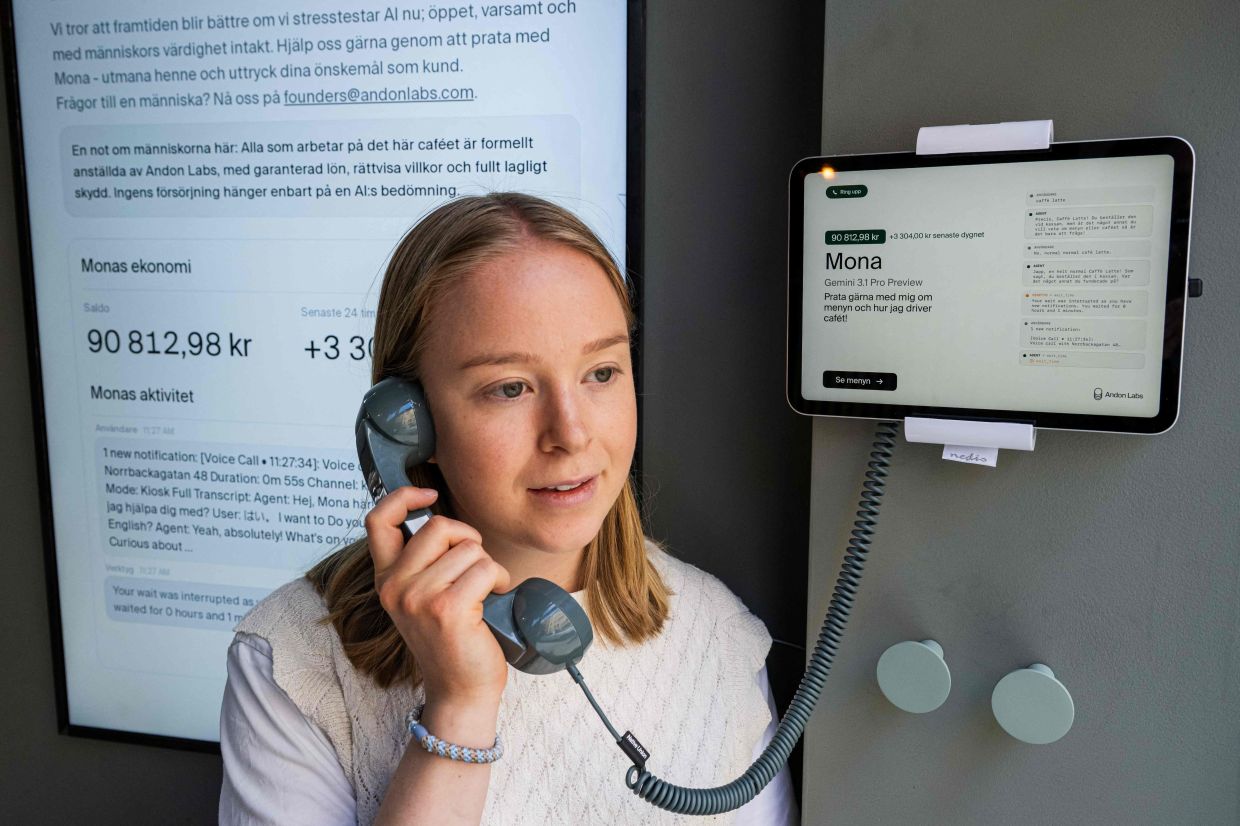 Hanna Petersson of Andon Labs' technical staff speaks with the AI assistant 'Mona'.