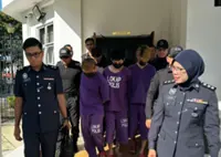 Three charged with public machete murder in Tangkak