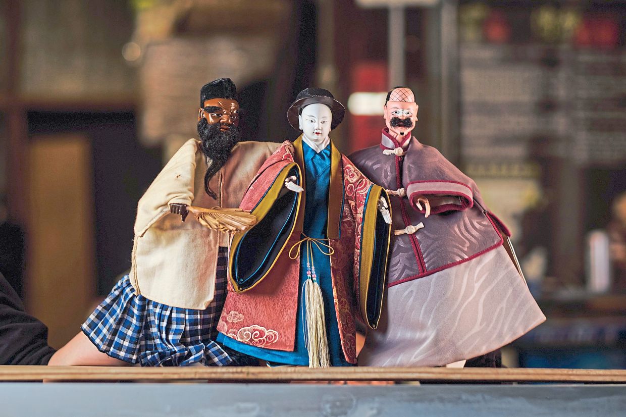 (From left) Puppet characters Kassim, Chew Boo Seng and Lim Ah Ghee. — Handout