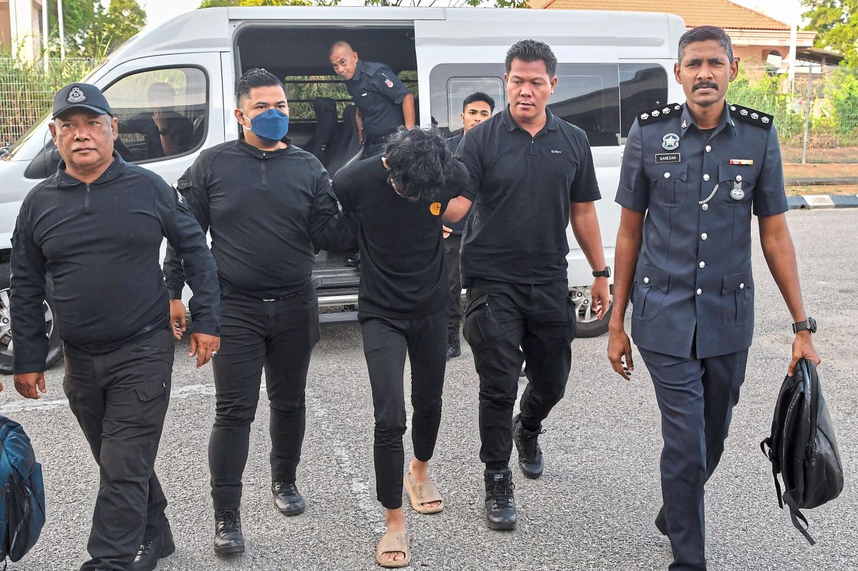 Court appearance: Muhammad Hazim arriving at the Magistrate’s Court in Kota Baru. He was charged with murdering a female college student about two weeks ago. — Bernama